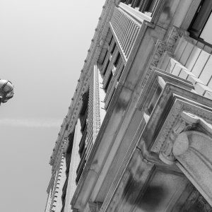 Black and white image of building exterior featuring intricate stone detail