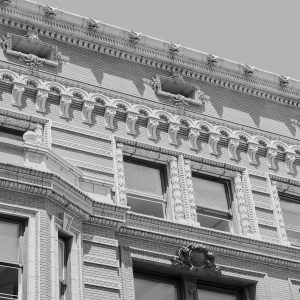 Black and white image of building exterior featuring intricate stone detail